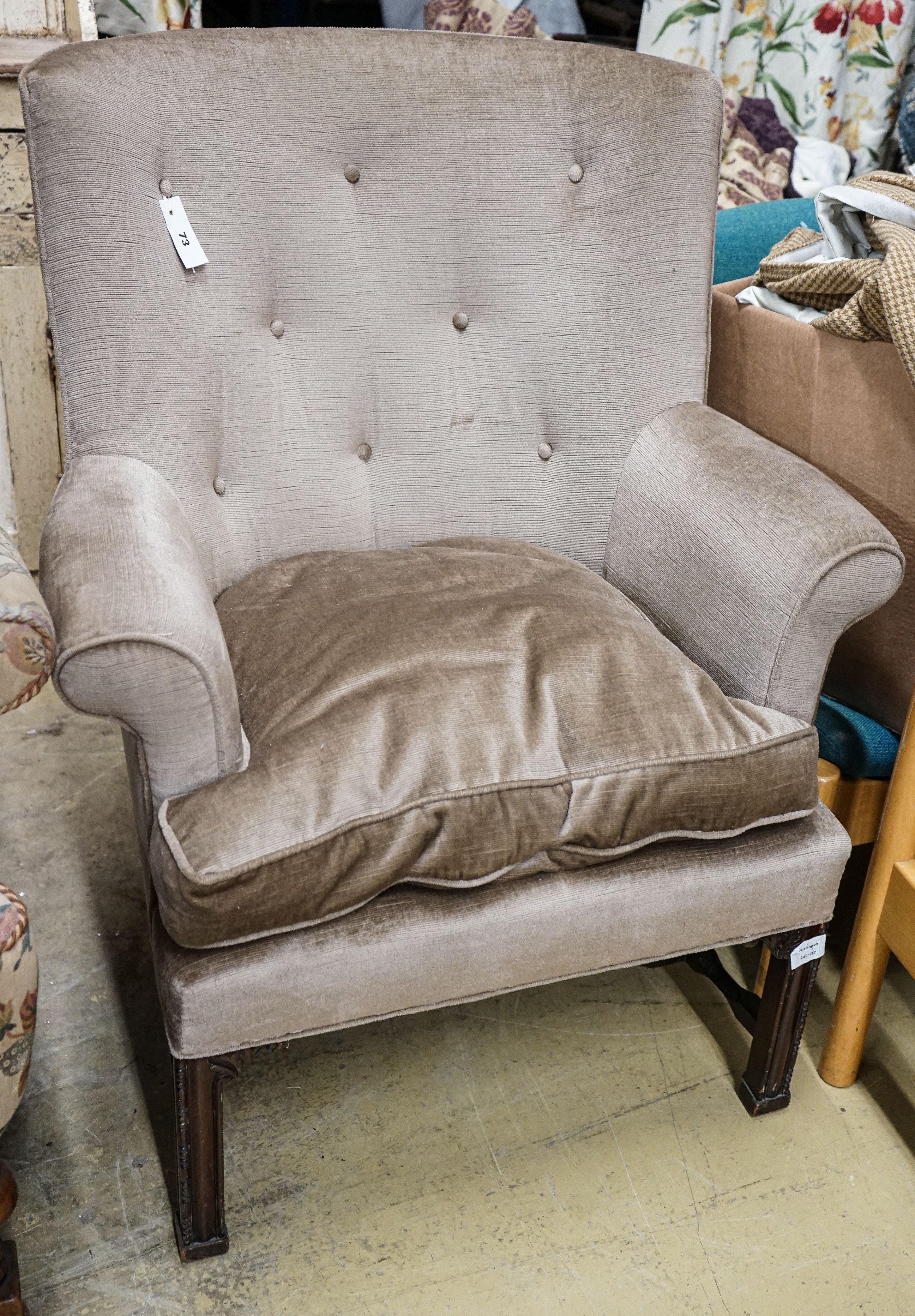 A George III style mahogany wing armchair, with carved squared legs, width 79cm, depth 60cm, height 101cm